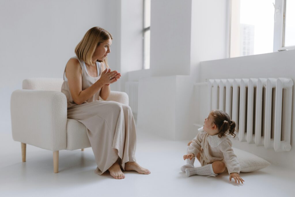 A mother and child engaged in a moment in a serene minimalist living room.